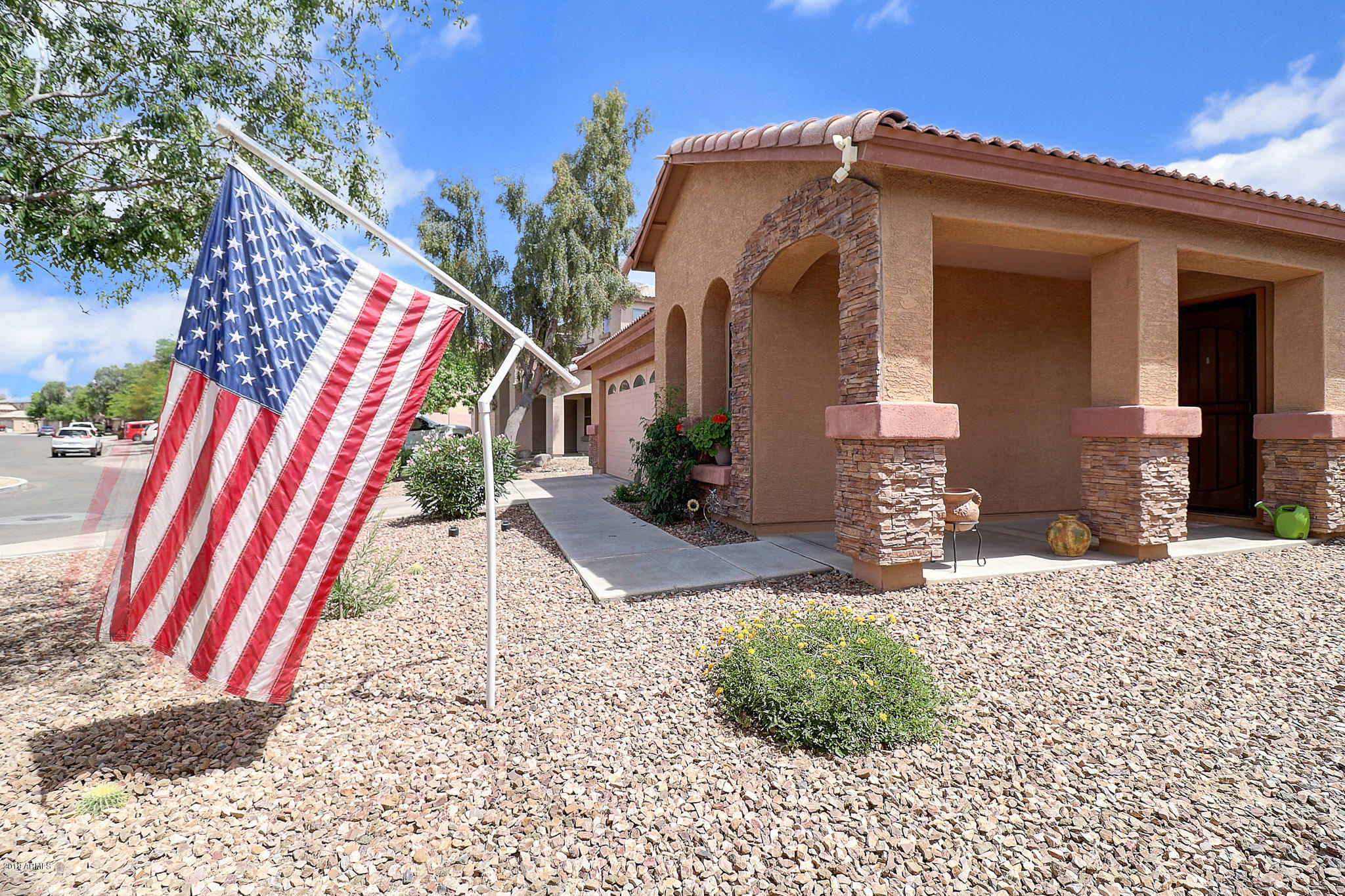 9947 West Riverside Avenue Tolleson, AZ 85353 - Photo 5 of 25 a front view of a house with a yard