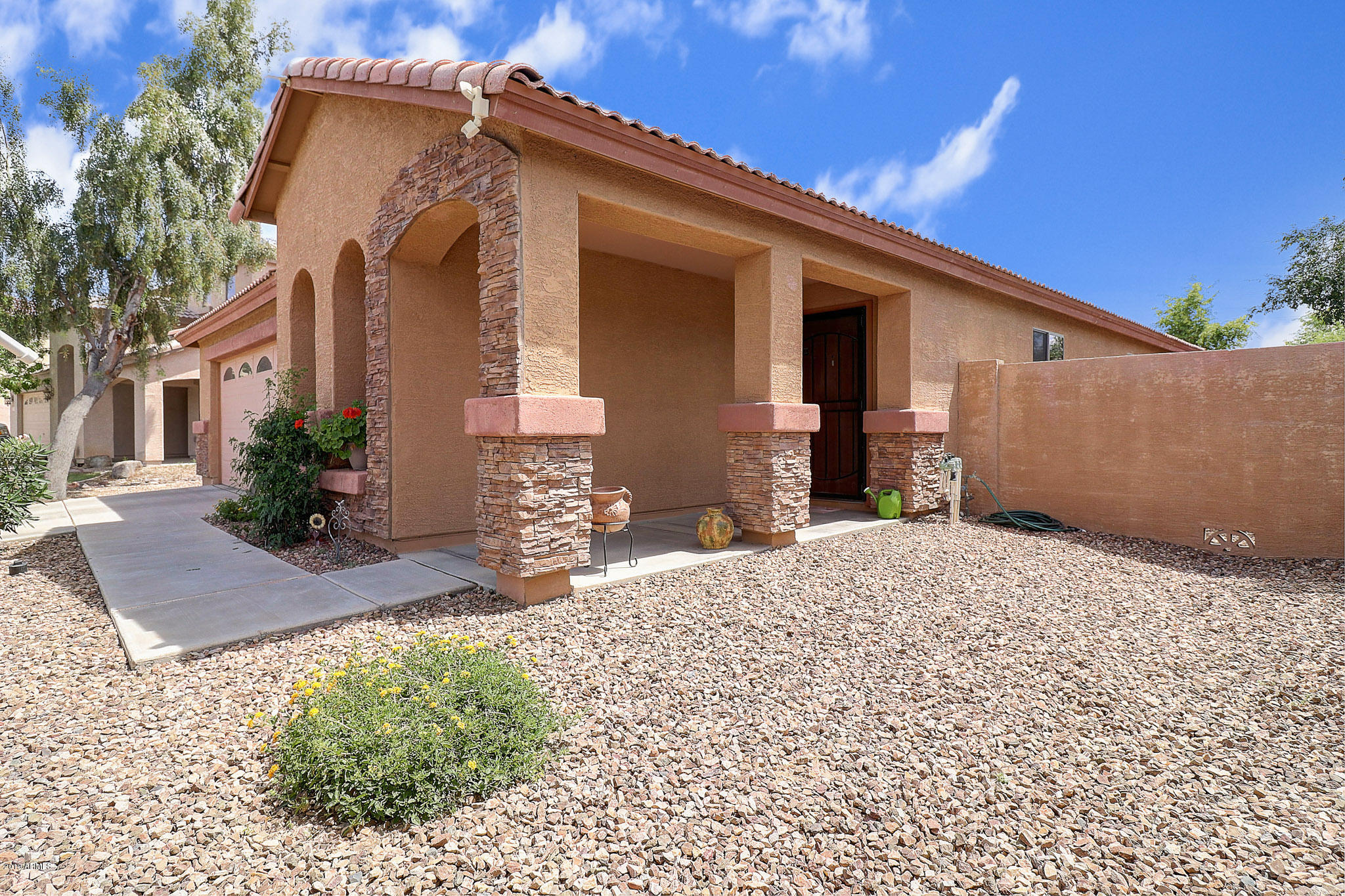 9947 West Riverside Avenue Tolleson, AZ 85353 - Photo 6 of 25 a front view of a house with a yard