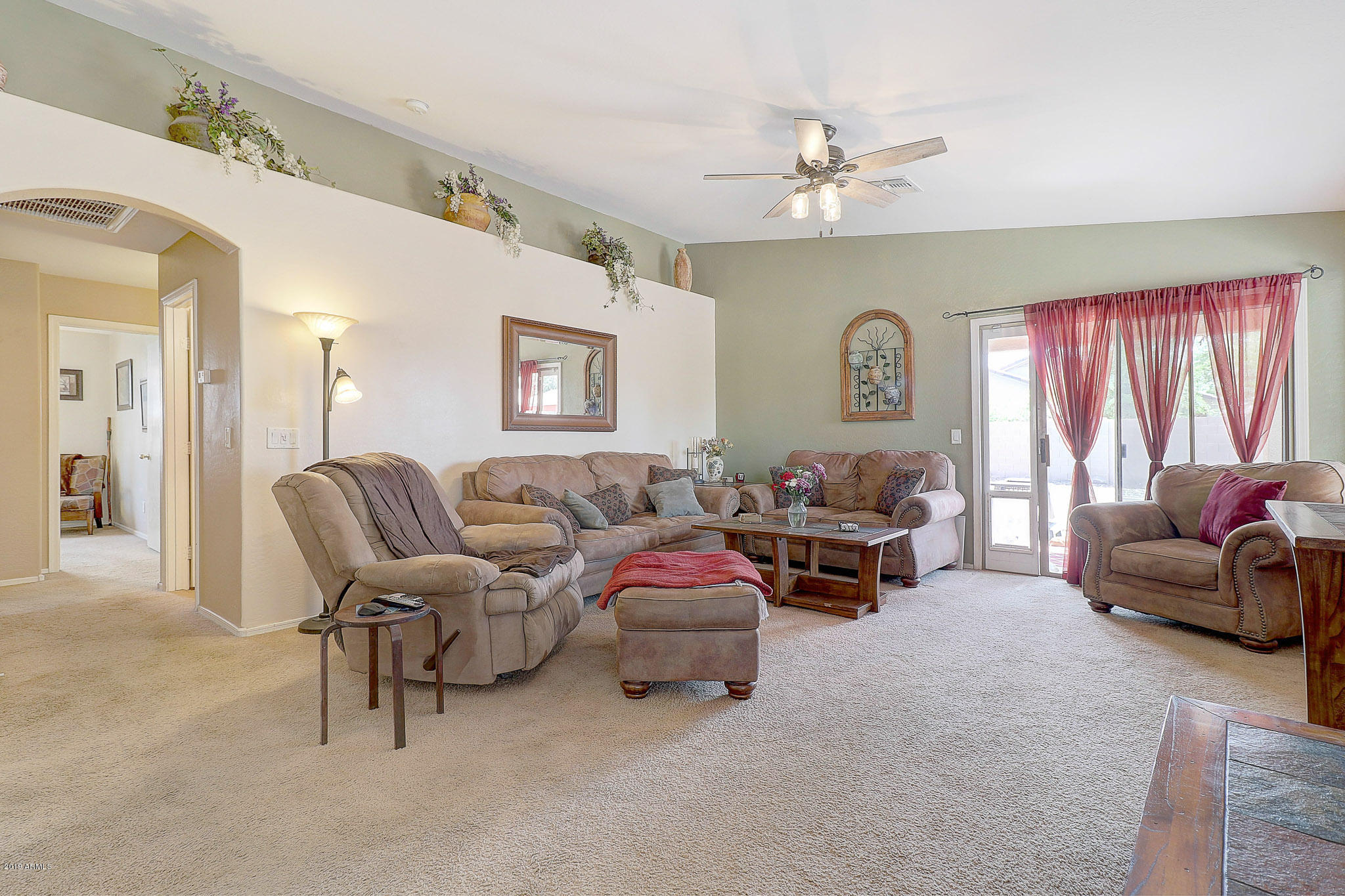 9947 West Riverside Avenue Tolleson, AZ 85353 - Photo 8 of 25 a living room with furniture and a chandelier