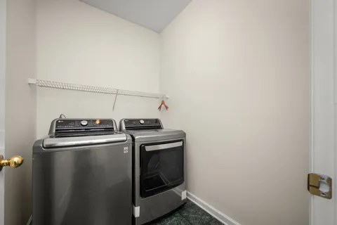a view of a storage and utility room with washer and dryer
