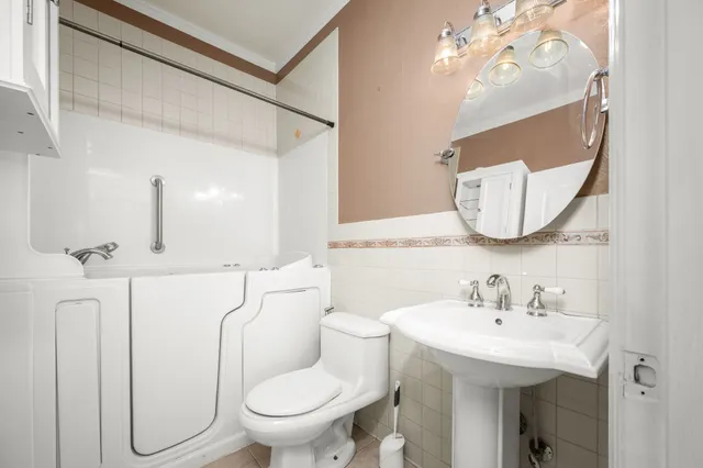 a bathroom with a toilet sink and mirror