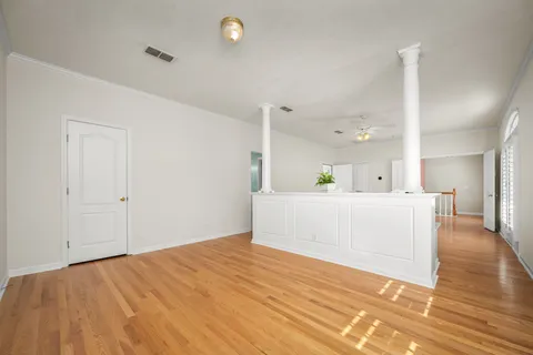 a view of a bedroom with wooden floor