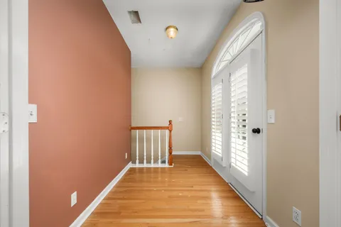 a view of a room with wooden floor and a window