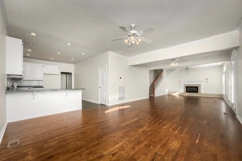 a view of empty room with kitchen and sink