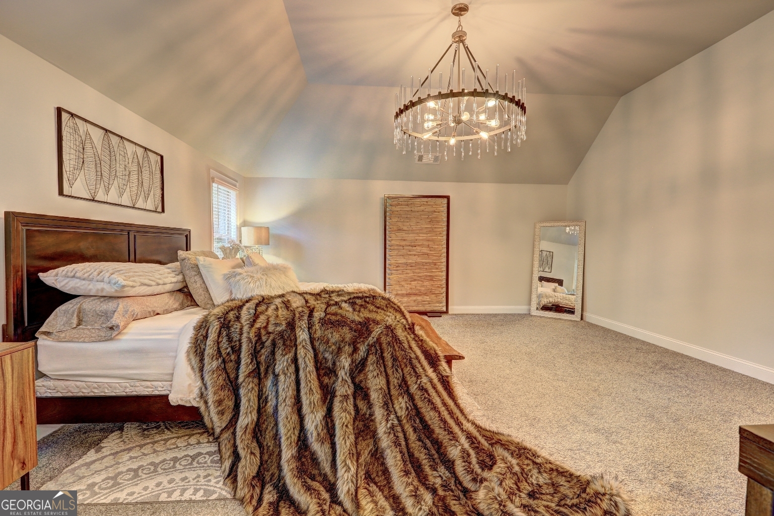 269 Baumgard Way Locust Grove, GA 30248 - Photo 13 of 23 a spacious bedroom with a bed and a chandelier