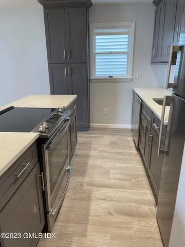 a kitchen with granite countertop a stove and a sink