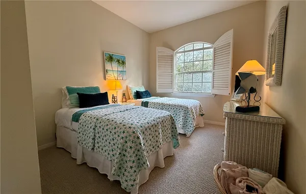 a bedroom with bed and window