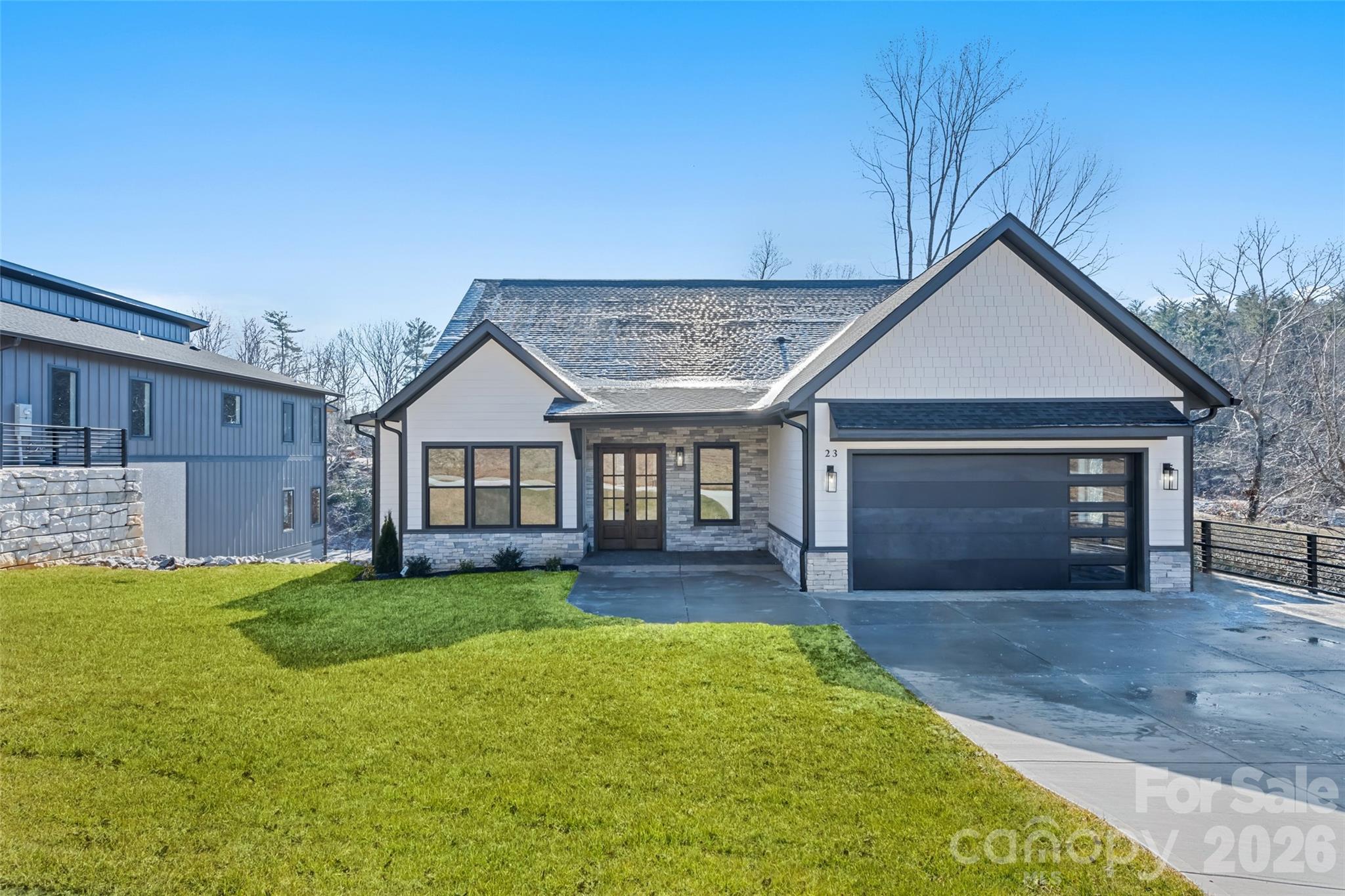 a front view of a house with a yard and garage