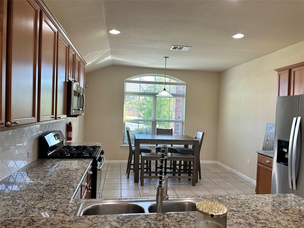401 Tula Trail Leander, TX 78641 - Photo 5 of 17 Kitchen with breakfast area & Stainless Steel appliances.
