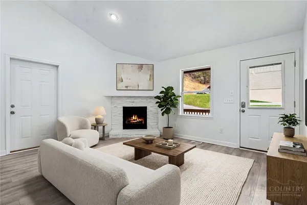 a living room with furniture and a fireplace