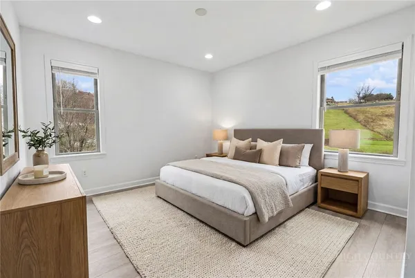 a bedroom with a bed and a window