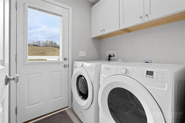 a view of a hallway with washer and dryer