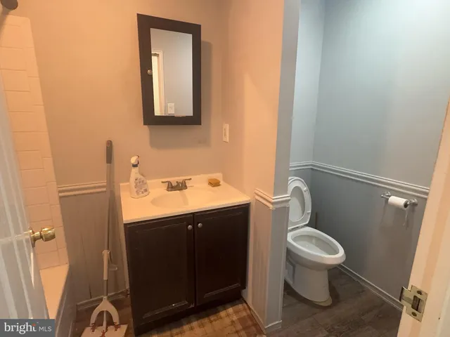 a bathroom with a toilet sink and mirror