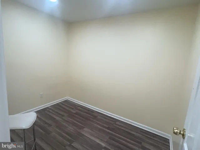 a view of a small space with wooden floor and a chair