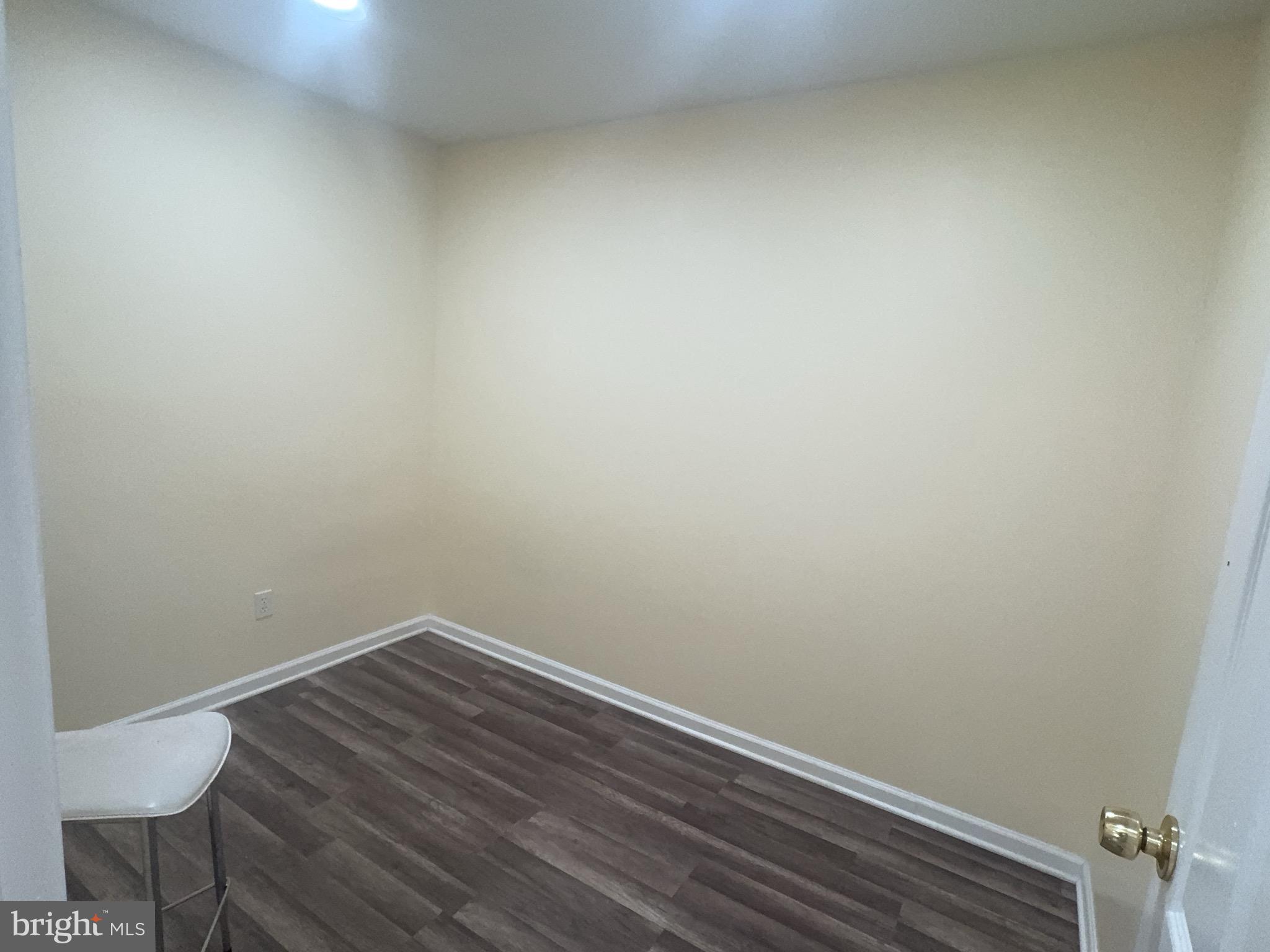 13008 Townsend Road, Unit L3 Philadelphia, PA 19154 - Photo 14 of 14 a view of a small space with wooden floor and a chair