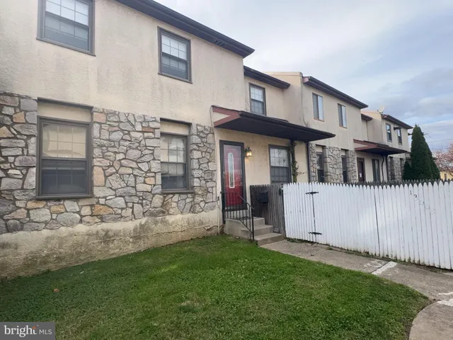a view of a house with a yard and sitting area