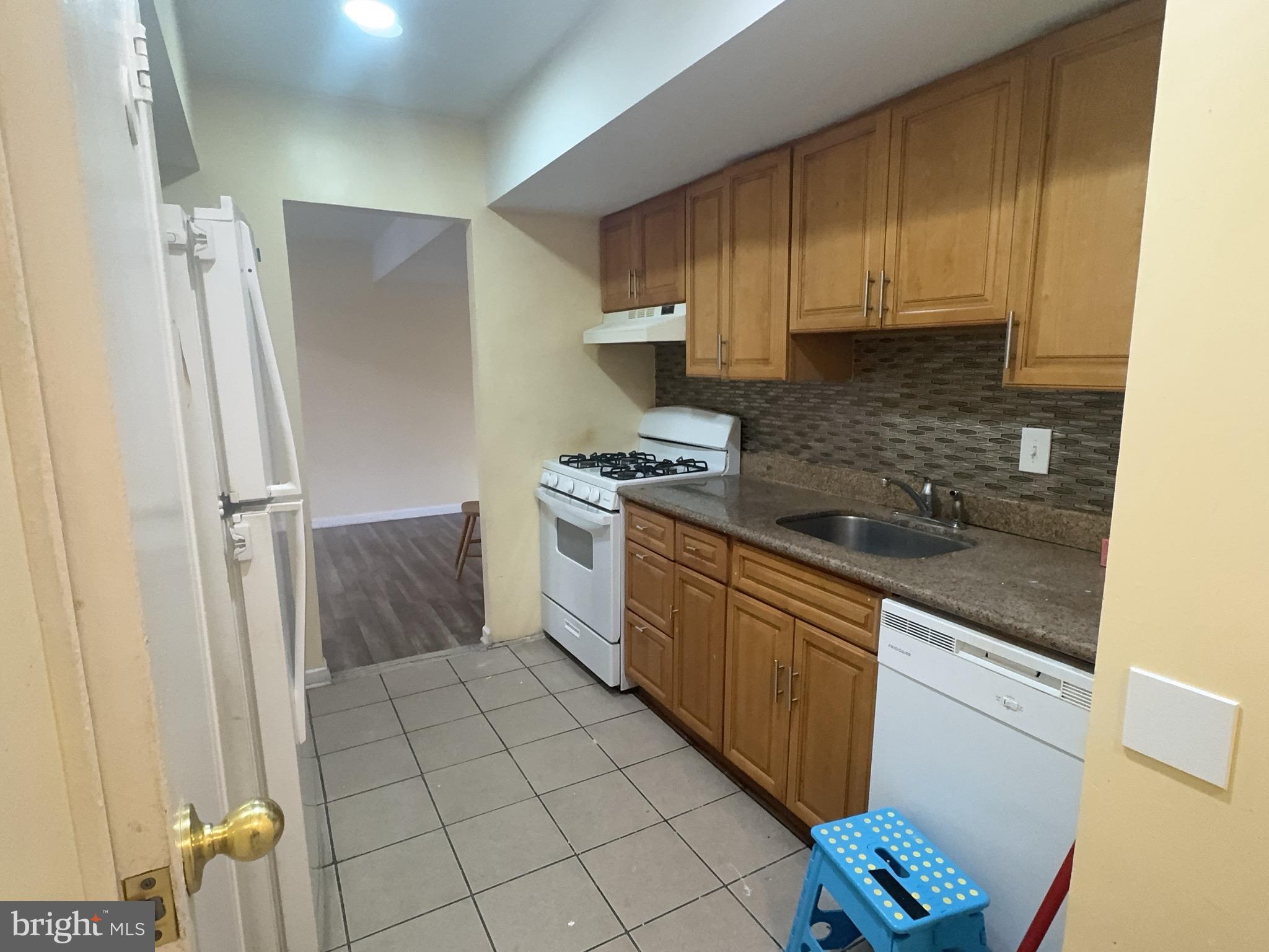 13008 Townsend Road, Unit L3 Philadelphia, PA 19154 - Photo 10 of 14 a kitchen with a sink a refrigerator and cabinets