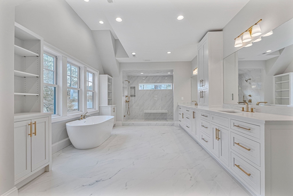 30 Hobart Road Wellesley, MA 02482 - Photo 11 of 40 a large bathroom with a granite countertop sink a large mirror and a bathtub