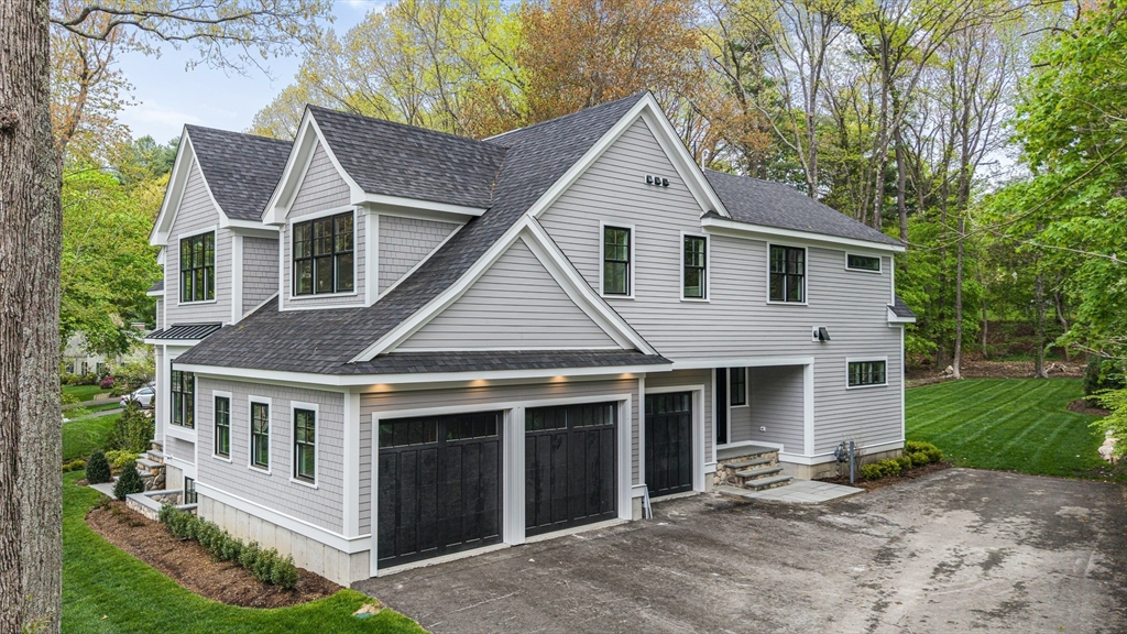 30 Hobart Road Wellesley, MA 02482 - Photo 2 of 40 a front view of a house with a yard and garage