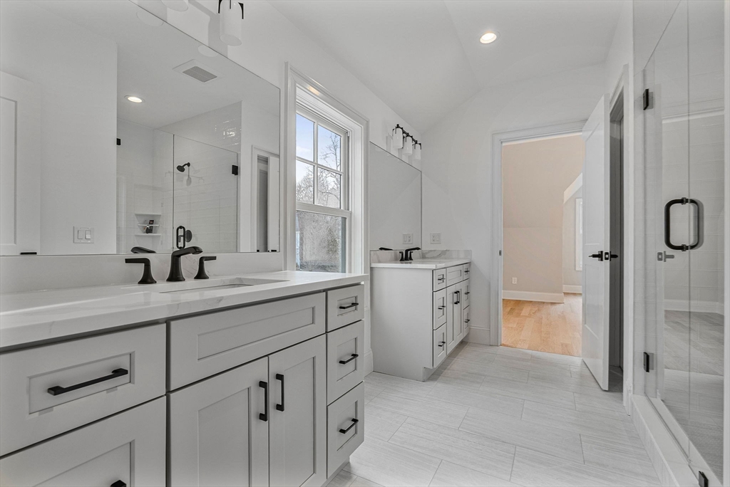 30 Hobart Road Wellesley, MA 02482 - Photo 21 of 40 a spacious bathroom with a double vanity sink a mirror a bathtub and shower
