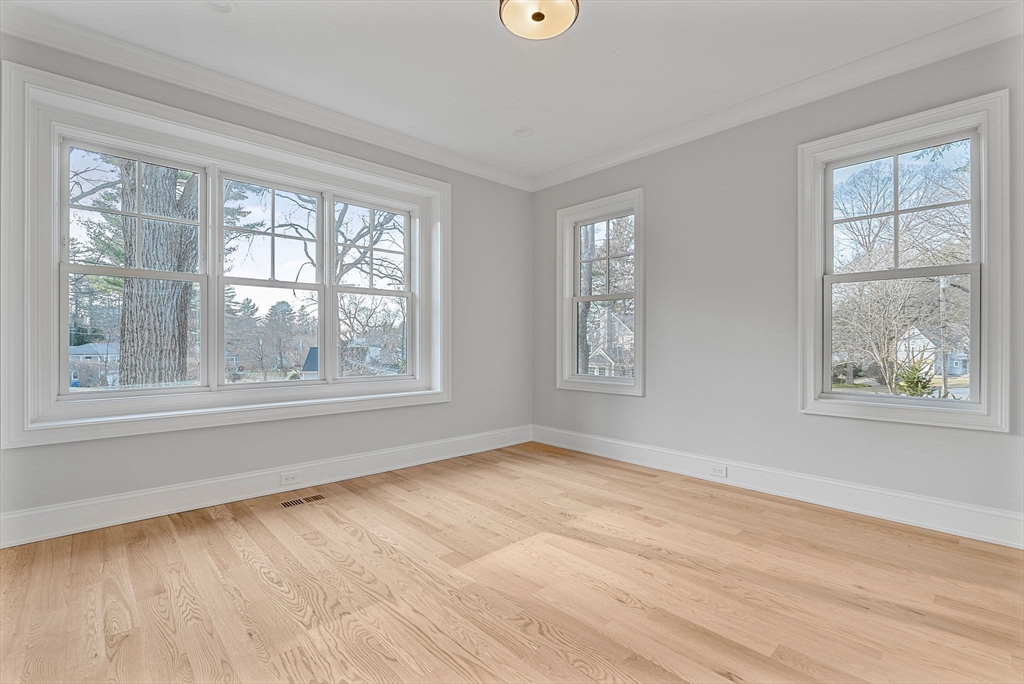30 Hobart Road Wellesley, MA 02482 - Photo 27 of 40 a view of an empty room with wooden floor and a window