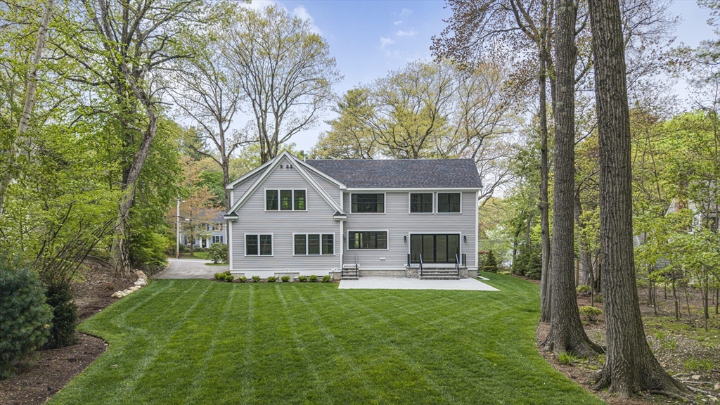 30 Hobart Road Wellesley, MA 02482 - Photo 40 of 40 a front view of a house with a yard table and chairs