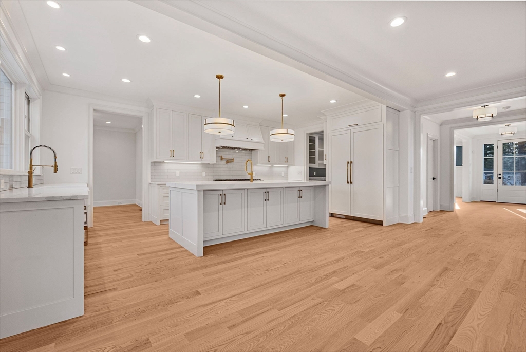30 Hobart Road Wellesley, MA 02482 - Photo 4 of 40 a large white kitchen with kitchen island a sink stainless steel appliances and cabinets