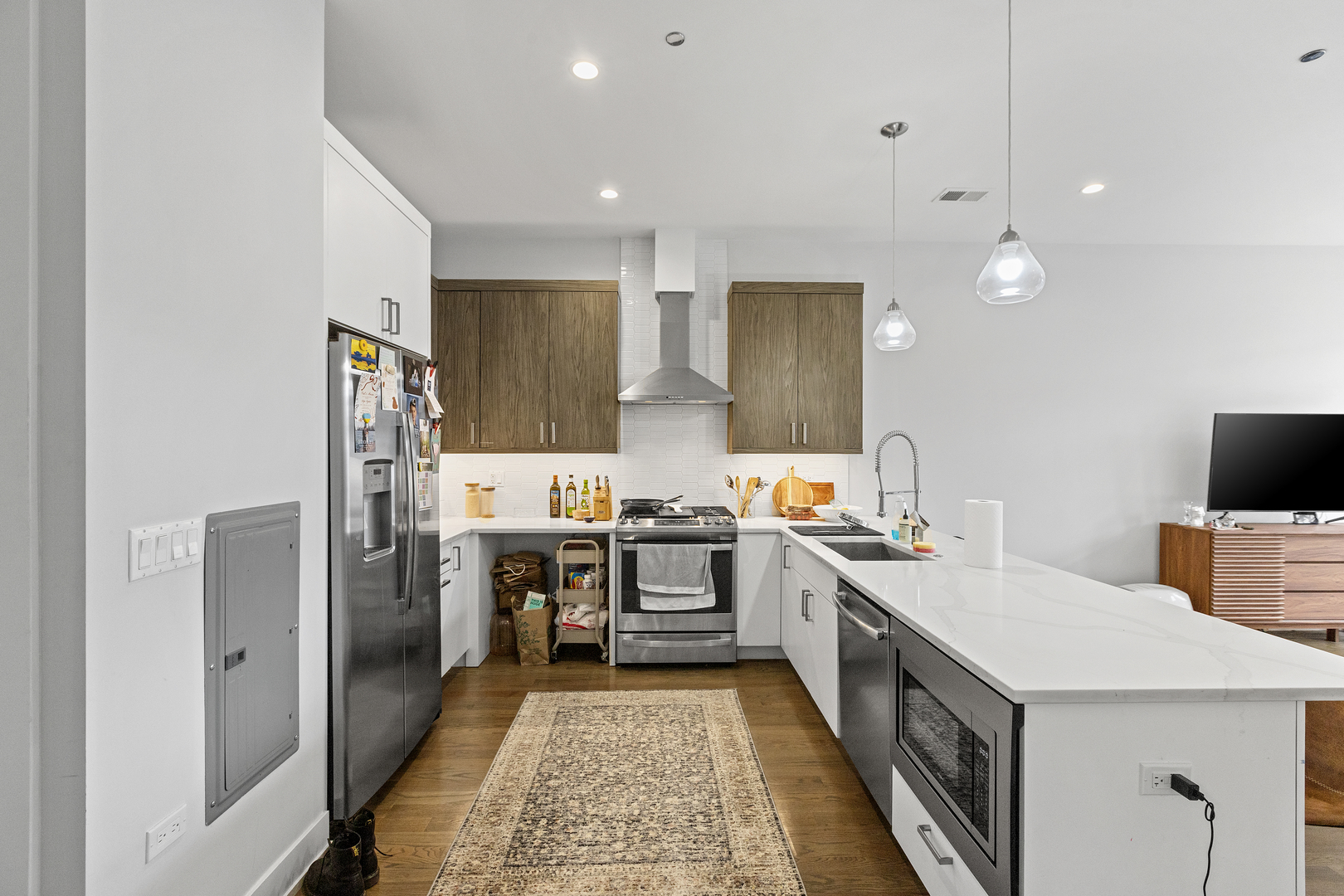 2217 West Madison Street, Unit 414 Chicago, IL 60612 - Photo 2 of 17 a kitchen with a sink a stove and chairs