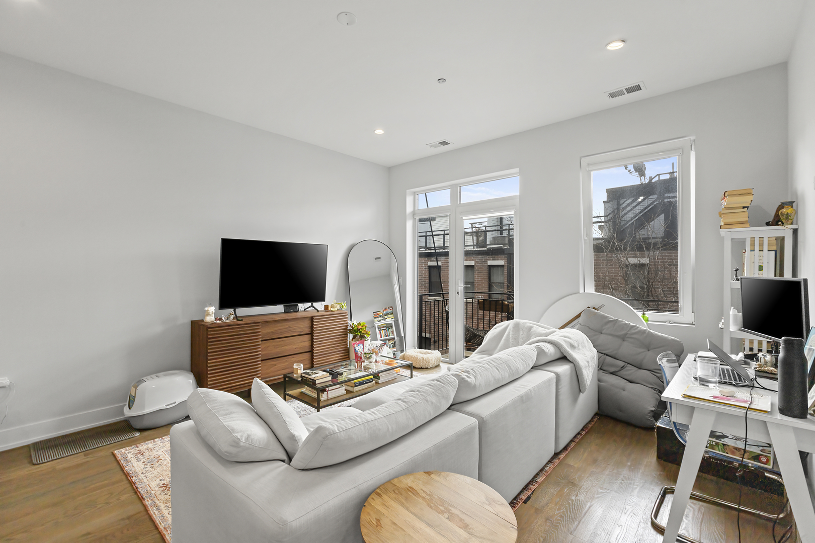 2217 West Madison Street, Unit 414 Chicago, IL 60612 - Photo 4 of 17 a living room with furniture a flat screen tv and a large window