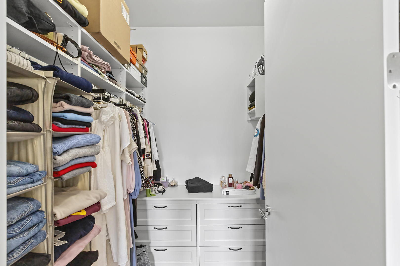 2217 West Madison Street, Unit 414 Chicago, IL 60612 - Photo 6 of 17 a view of walk in closet with clothes and shoes