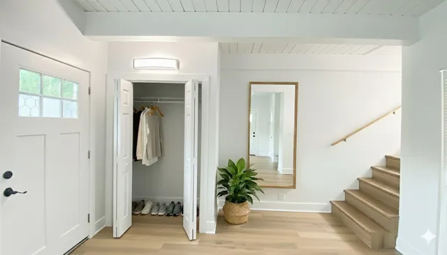 a view of a hallway with wooden floor and front door