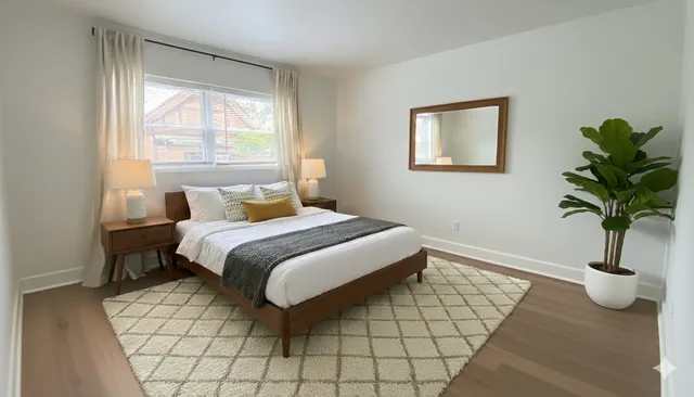 a bedroom with a bed lamp and window