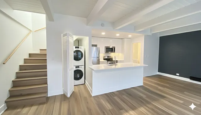 a view of living room with furniture and wooden floor