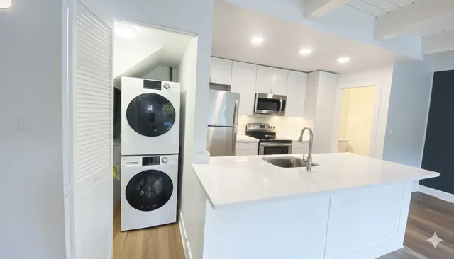 a kitchen with stainless steel appliances a microwave a stove top oven a counter space and cabinets