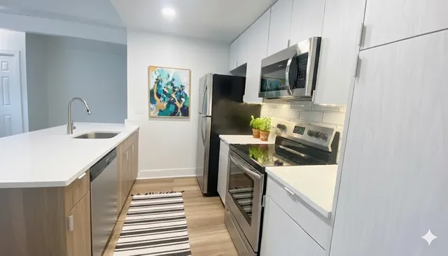 a kitchen with a sink stove and microwave