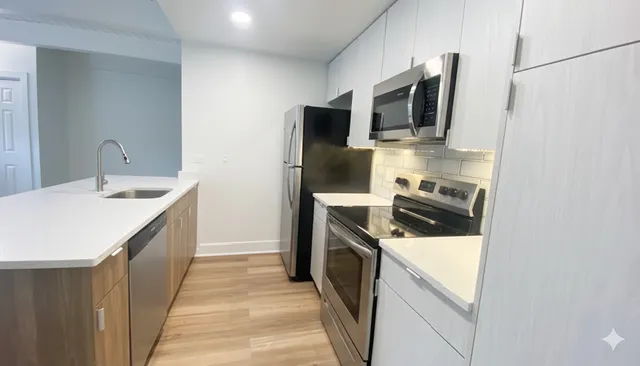 a kitchen with a sink stove and microwave
