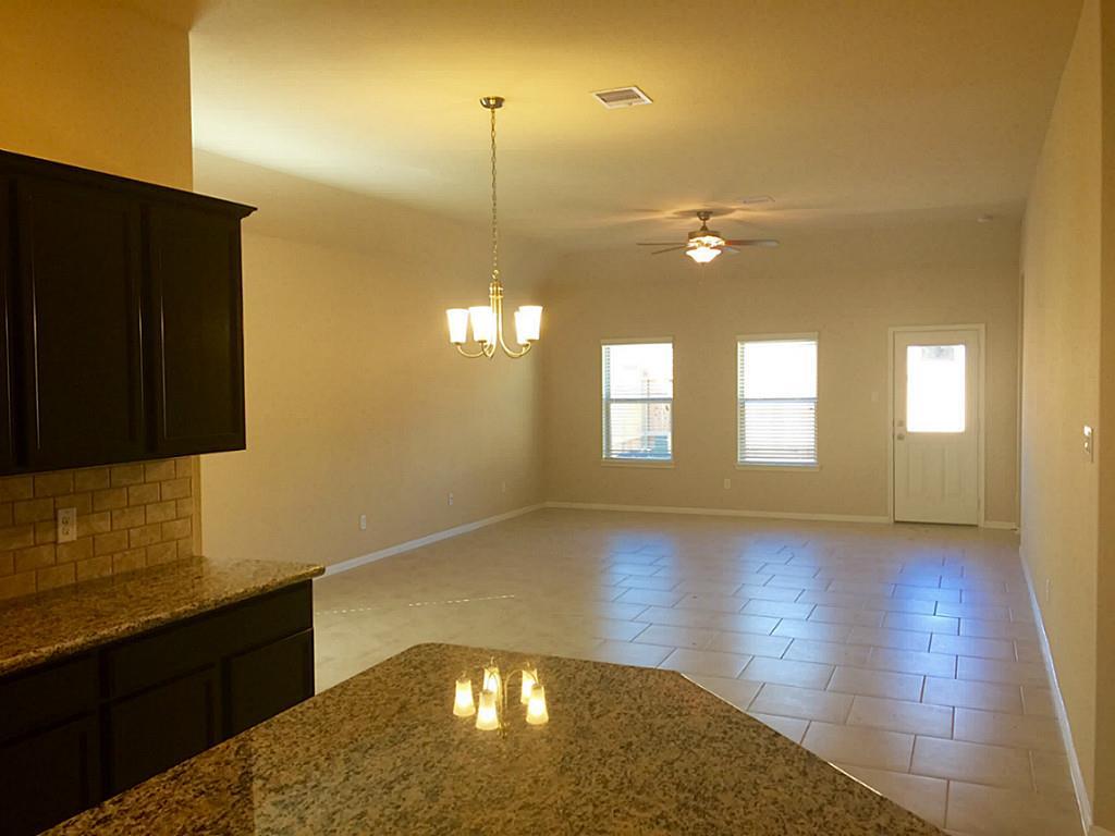 618 Longstreet Drive Rosenberg, TX 77469 - Photo 14 of 23 a view of an empty room with window and wooden floor