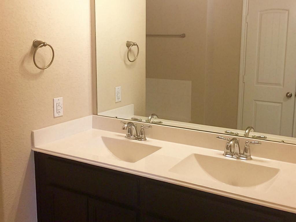 618 Longstreet Drive Rosenberg, TX 77469 - Photo 16 of 23 a bathroom with a sink double vanity and mirror