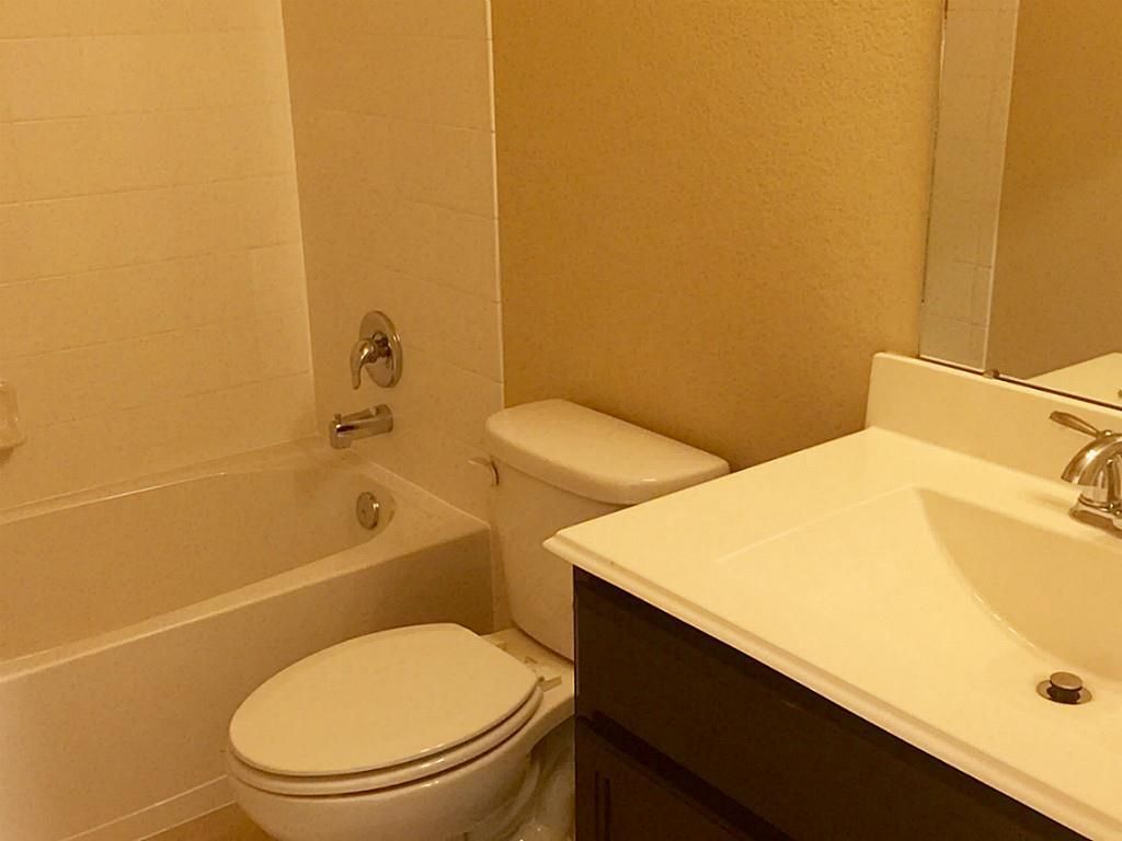 618 Longstreet Drive Rosenberg, TX 77469 - Photo 17 of 23 a bathroom with a toilet and a sink