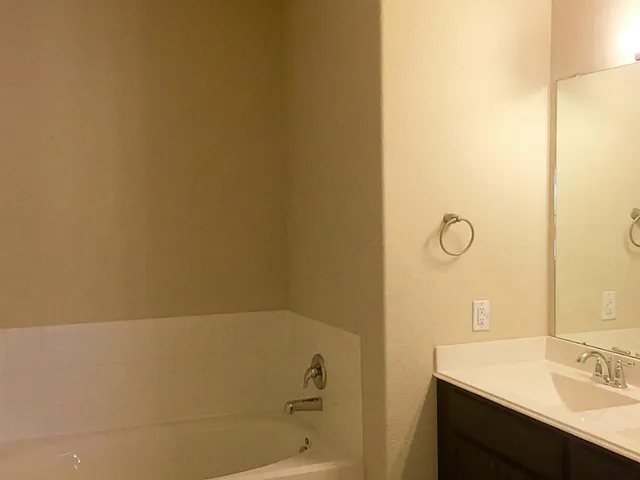 a bathroom with a bathtub and a sink