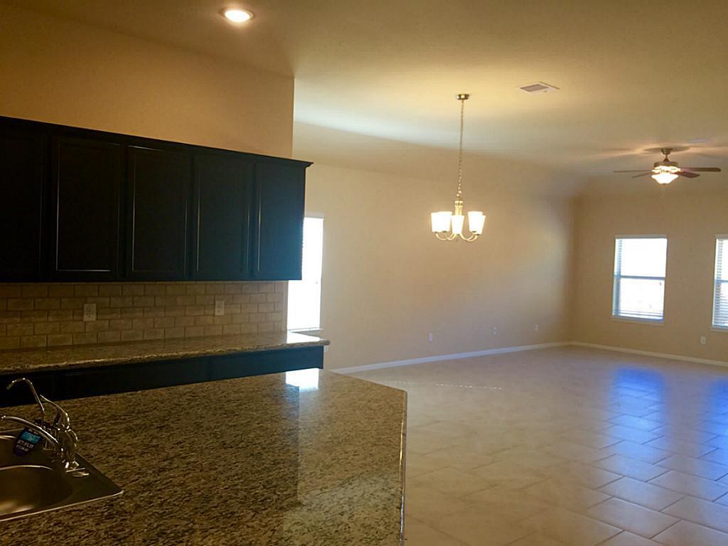 618 Longstreet Drive Rosenberg, TX 77469 - Photo 5 of 23 a kitchen with a sink wooden floor and a window