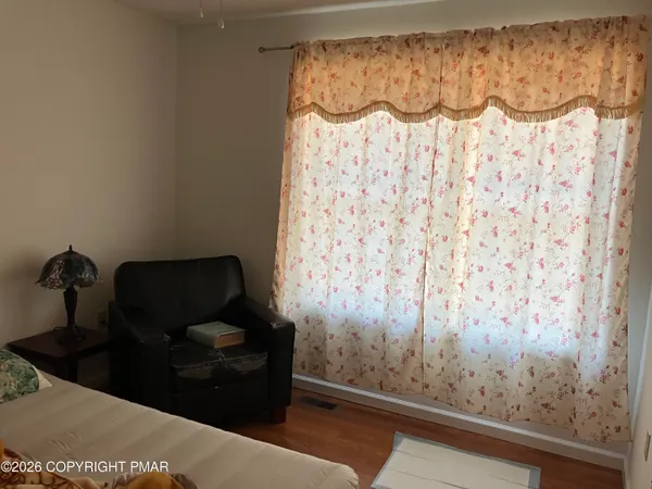 a living room with a couch and a curtain