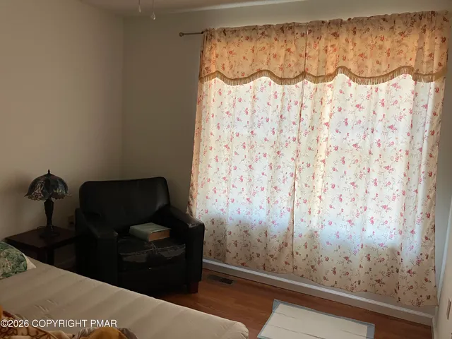 a living room with a couch and a curtain