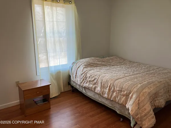 a bed sitting in a bedroom next to a window