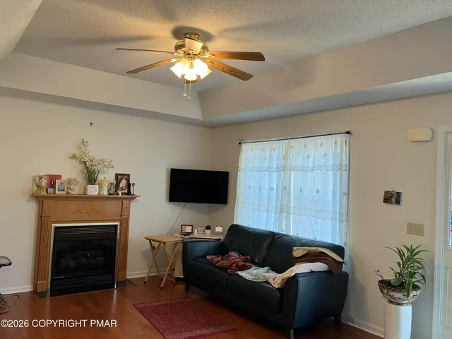 a living room with furniture a fireplace and a flat screen tv