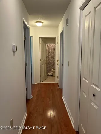 a view of hallway with wooden floor