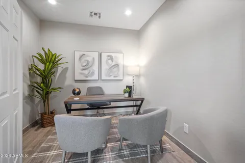 a living room with furniture and a potted plant