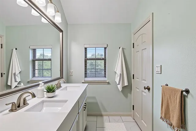 a bathroom with a tub sink and mirror