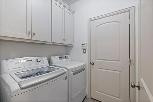 a view of storage and utility room with washer and dryer