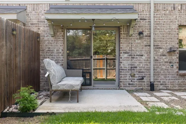 a view of a porch with chairs and a yard